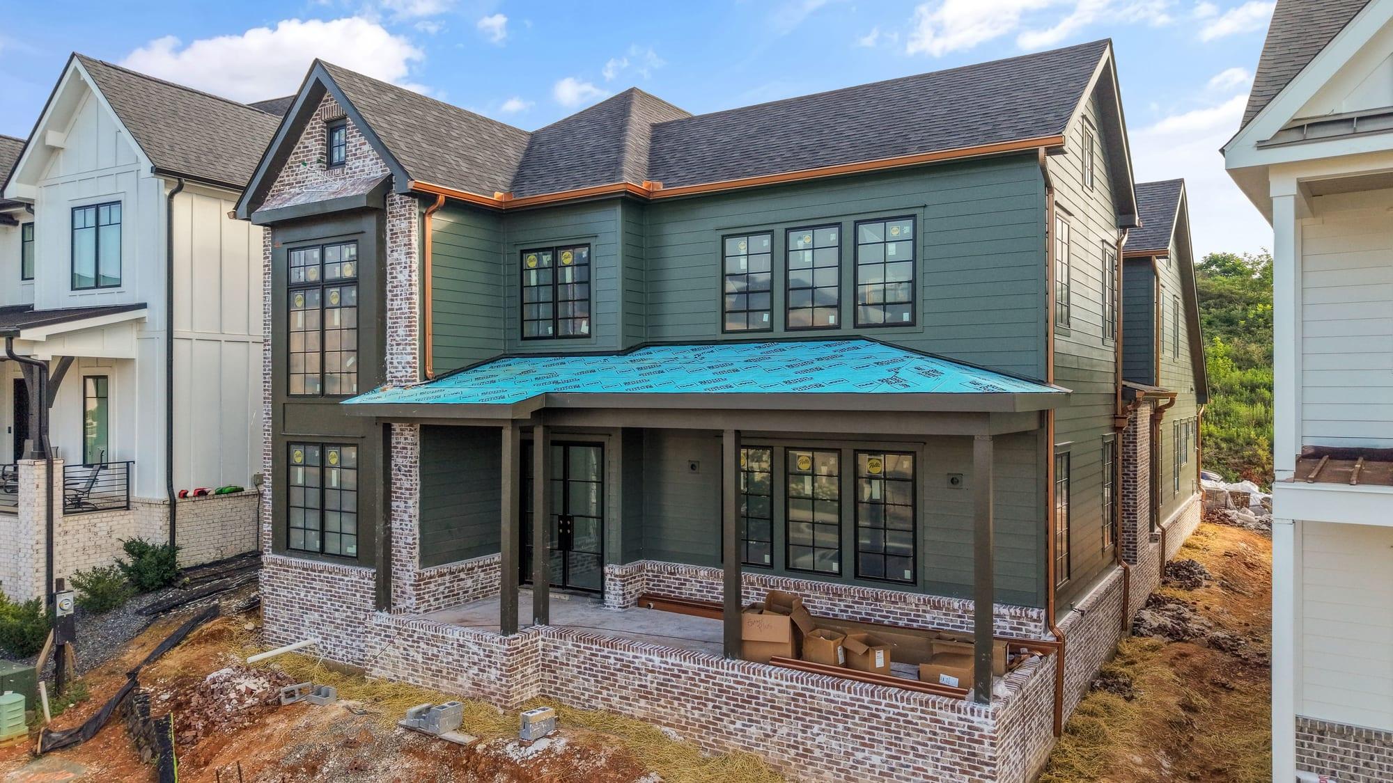 Green craftsman rear elevation mid-build with roof underlayment