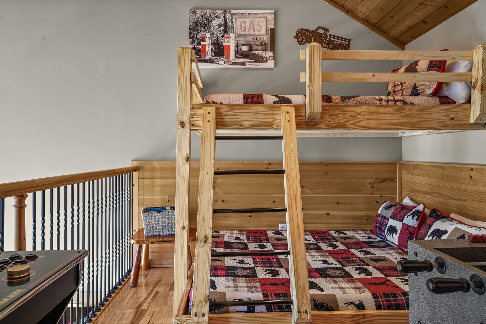 Timber bunk beds with lodge quilts in the cabin loft