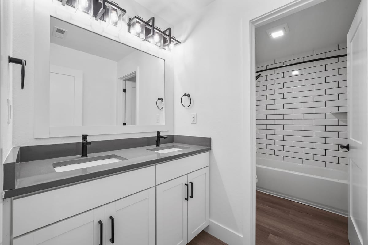 Double-vanity bathroom with black hardware (detail crop)