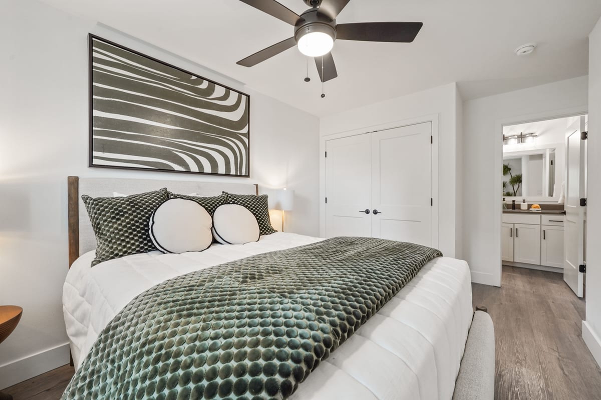 Staged bedroom in a green and white palette (detail crop)