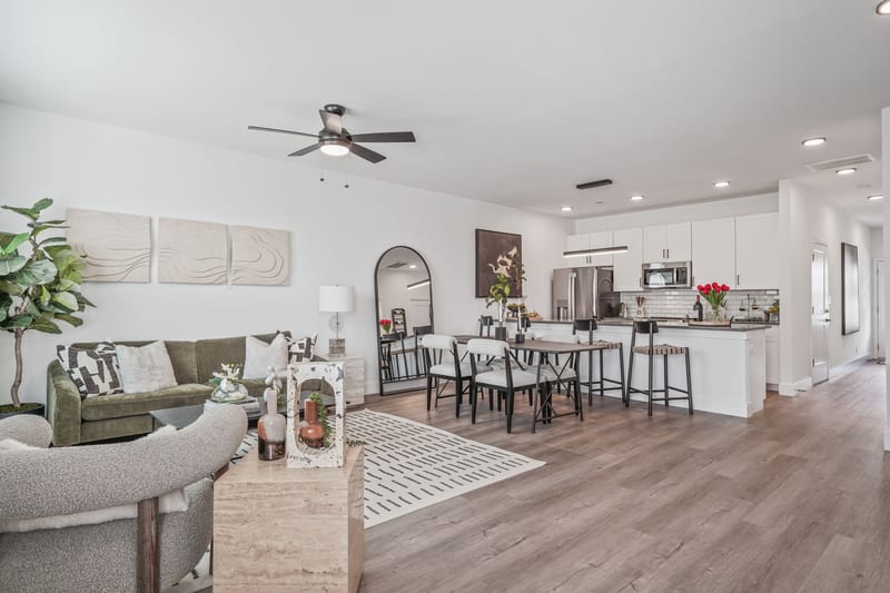 Staged model-unit living, dining, and kitchen in one open plan