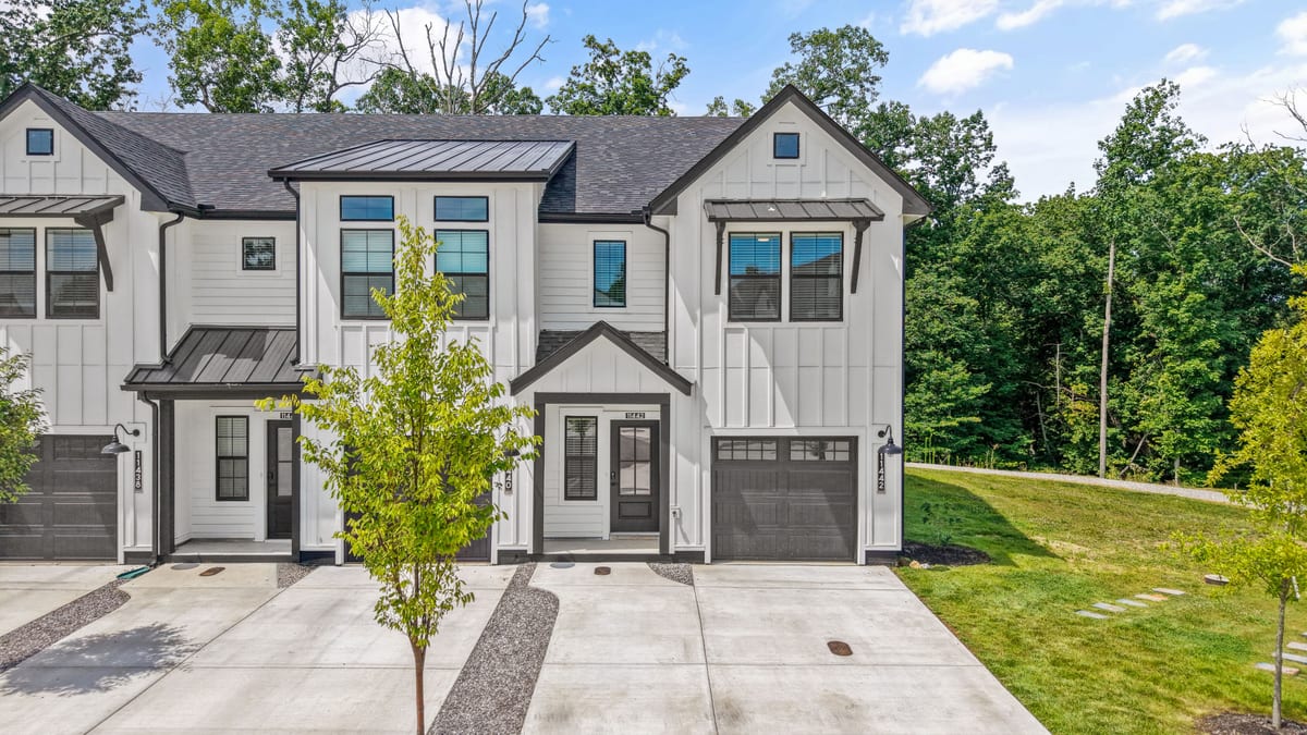 Townhome front elevation with farmhouse gables and metal roof accents