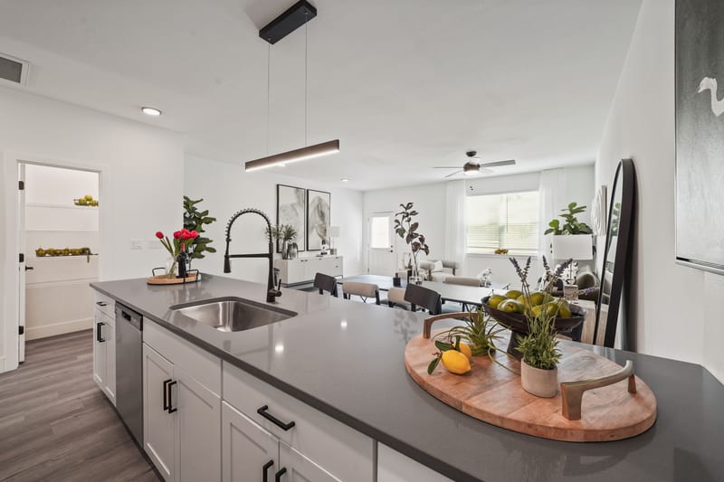Styled unit kitchen island with subway tile and grey quartz