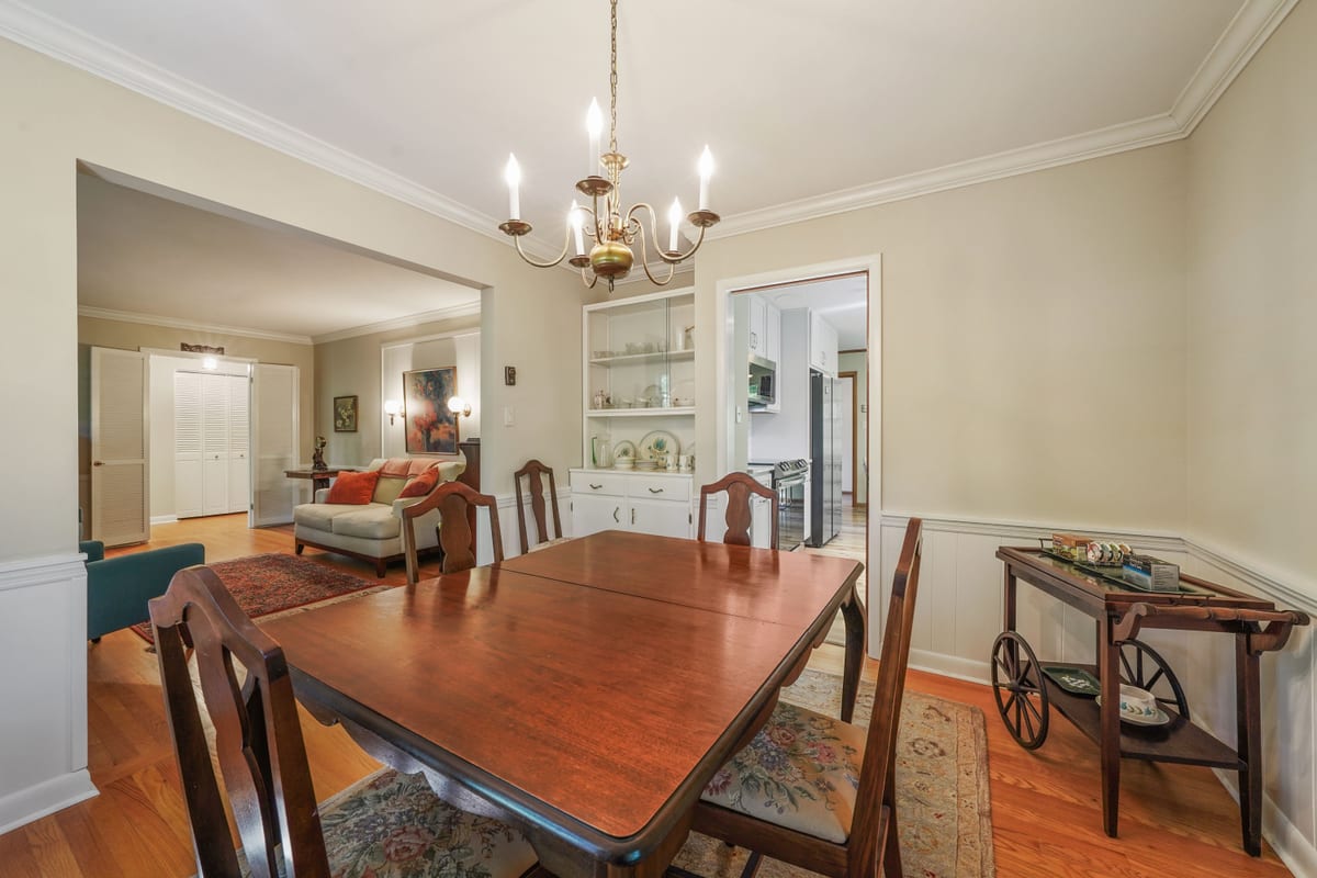 Dining room with mahogany table, chandelier, and hutch (detail crop)