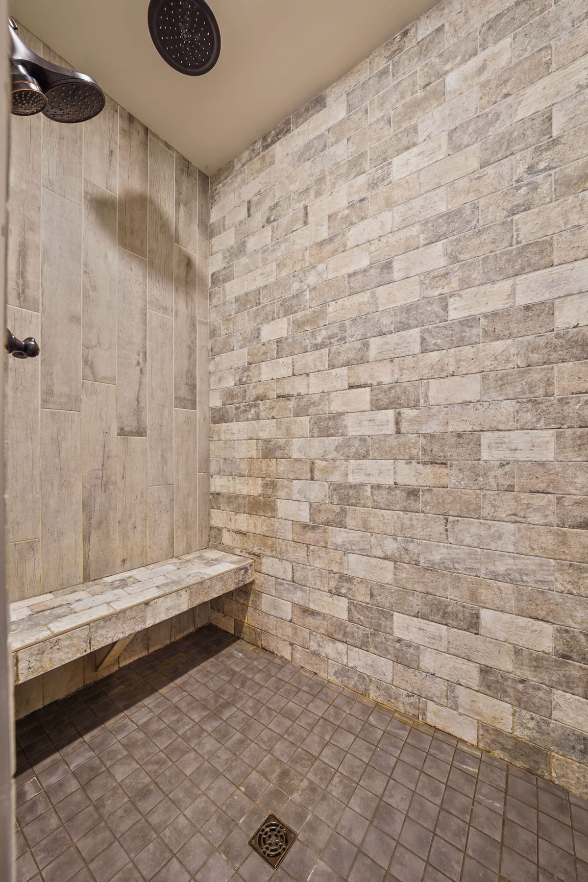 Stacked-stone walk-in shower with bench (detail crop)