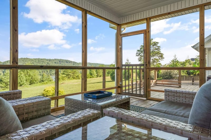 Screened porch opening onto a long green valley view