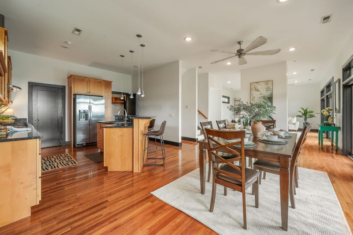Open dining-to-kitchen flow beside the staircase