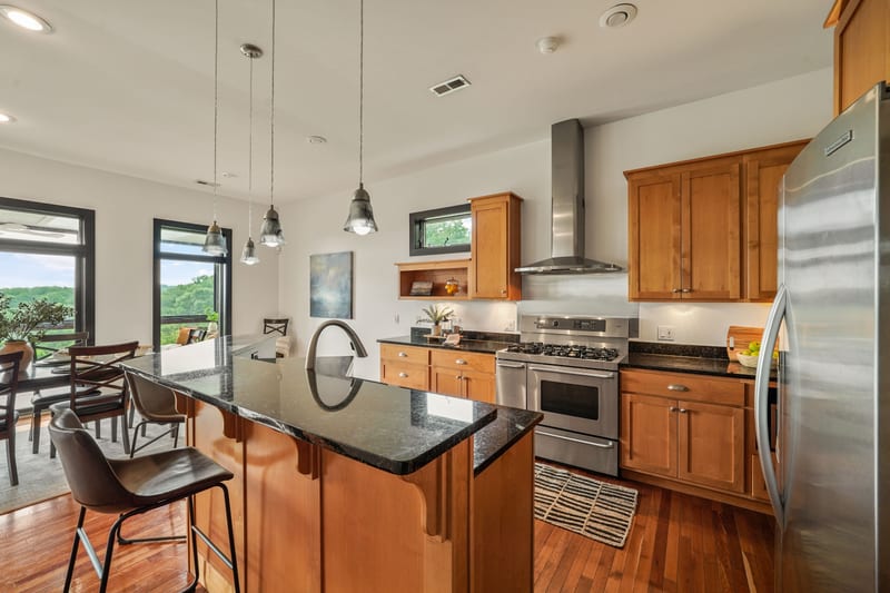 Kitchen island and pendants in front of ridge-view windows