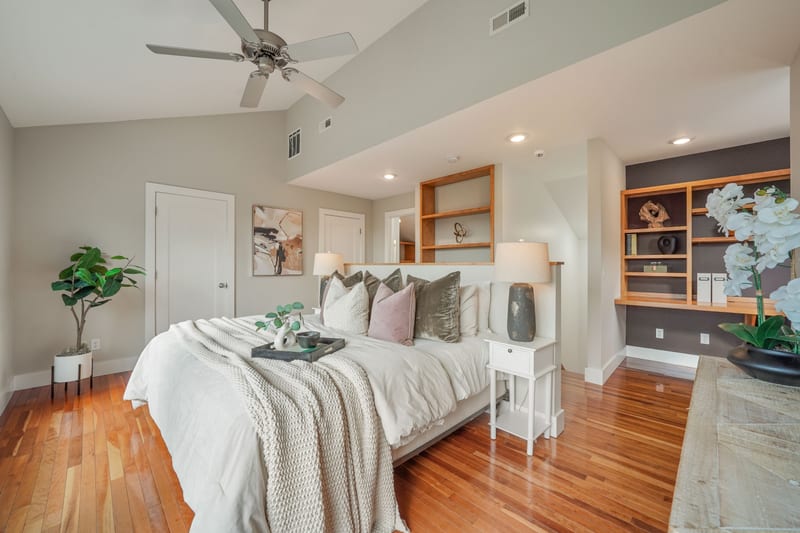 Primary bedroom with view windows and built-ins