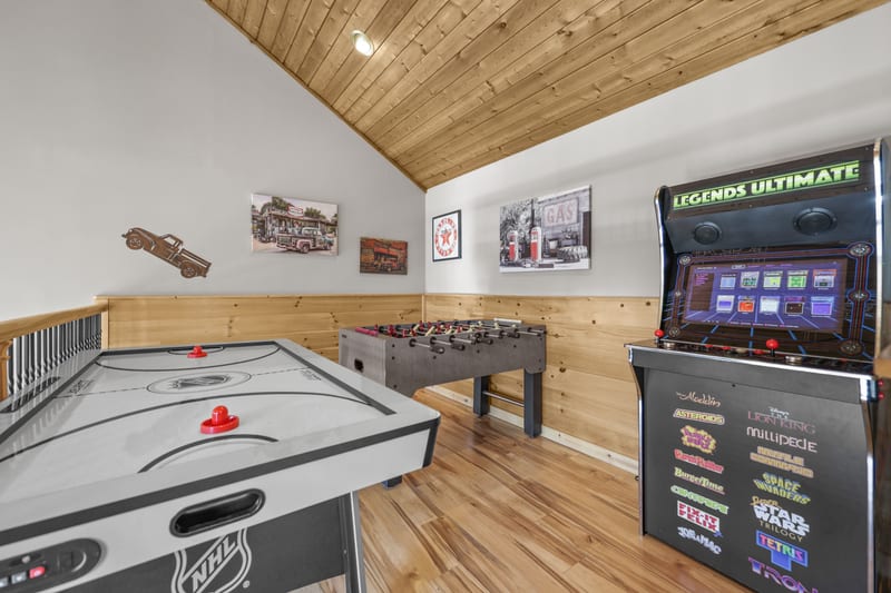 Cabin game loft with air hockey, foosball, and arcade cabinet