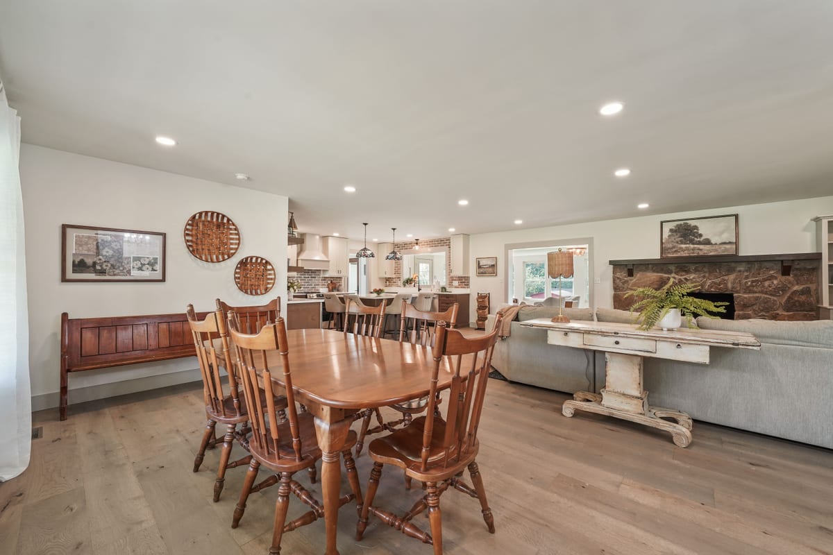 Dining room staged with an antique table and church pew
