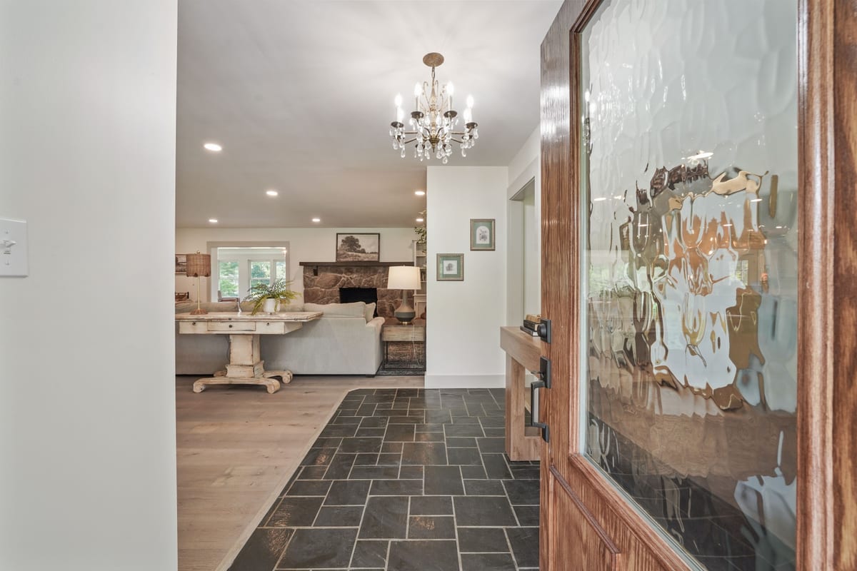 Entry hall with slate floor and textured-glass front door
