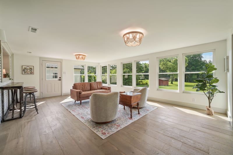 Sunroom sitting area lined with windows